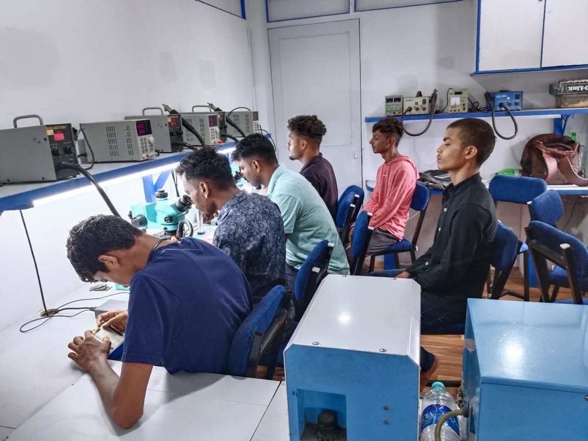 MOBNET students practising mobile hardware repair in the training lab
